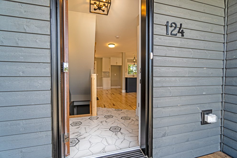 Inspiration for a small transitional ceramic tile and gray floor front door remodel with a brown front door