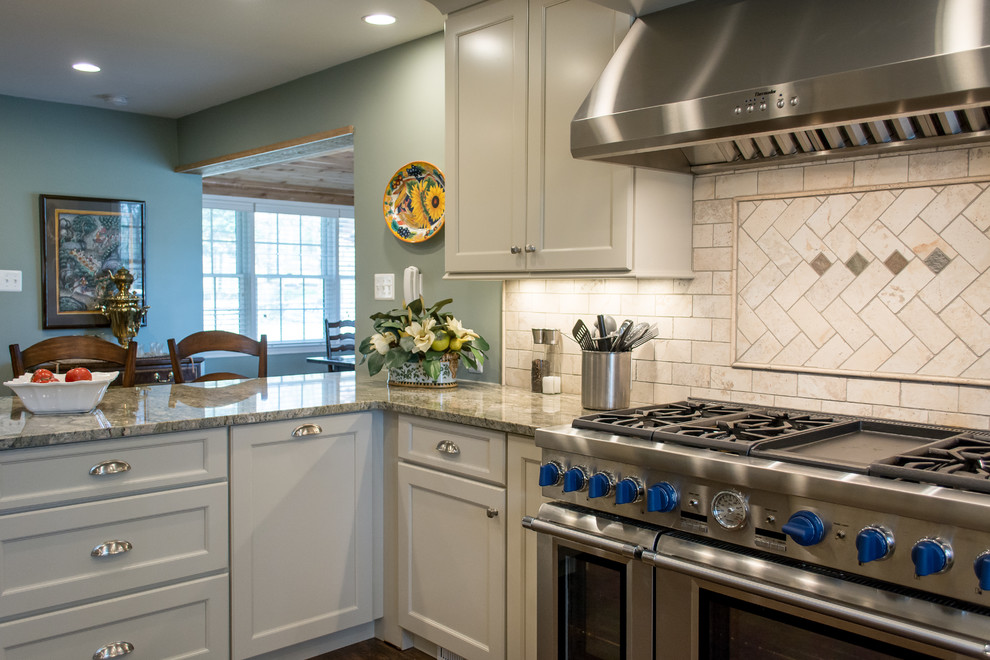 Example of a mid-sized transitional u-shaped dark wood floor eat-in kitchen design in DC Metro with gray cabinets, granite countertops, beige backsplash, stainless steel appliances, beaded inset cabinets, a peninsula, an undermount sink and stone tile backsplash