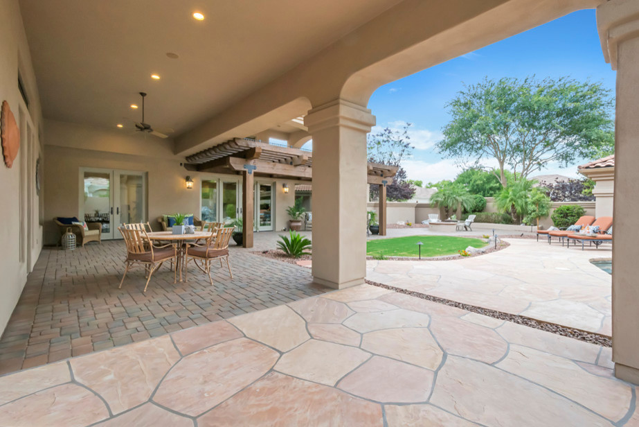Large transitional backyard concrete paver patio photo in Phoenix with a fire pit and a pergola
