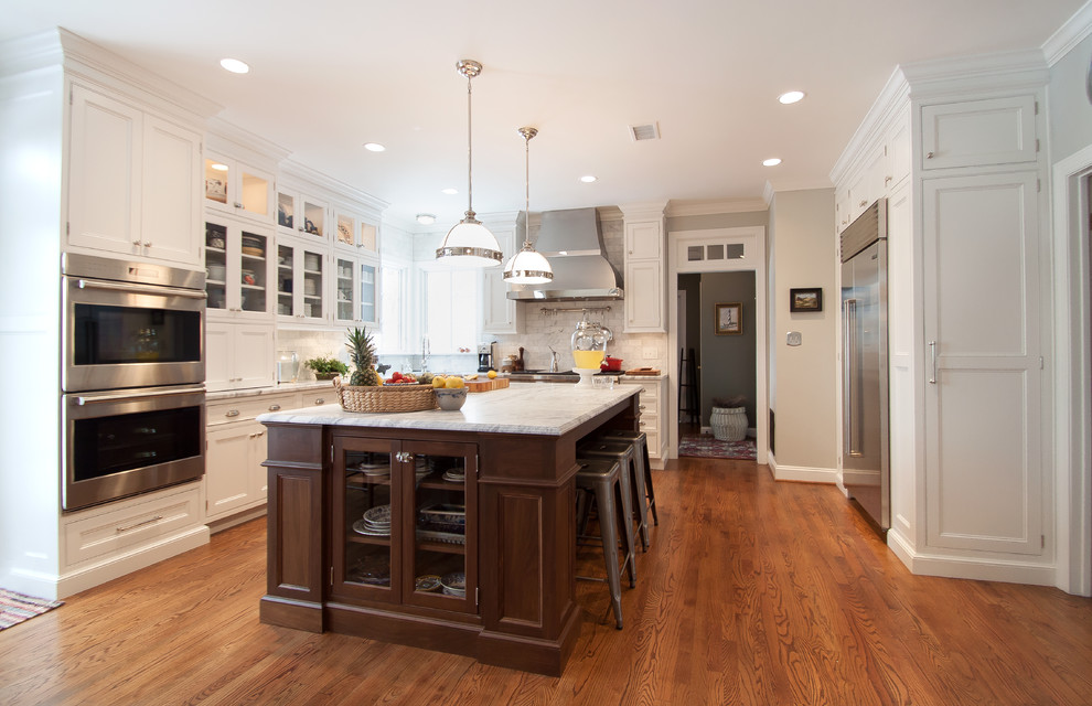 Large transitional kitchen photo in DC Metro with beaded inset cabinets, white cabinets, marble countertops, white backsplash, subway tile backsplash, stainless steel appliances and an island