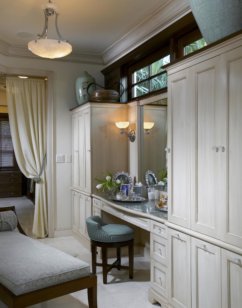 Mid-sized transitional women's dressing room in Miami with light wood cabinets, white floor and recessed-panel cabinets.