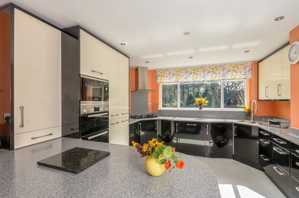 Design ideas for a mid-sized modern kitchen in Other with black cabinets, solid surface benchtops and grey splashback.