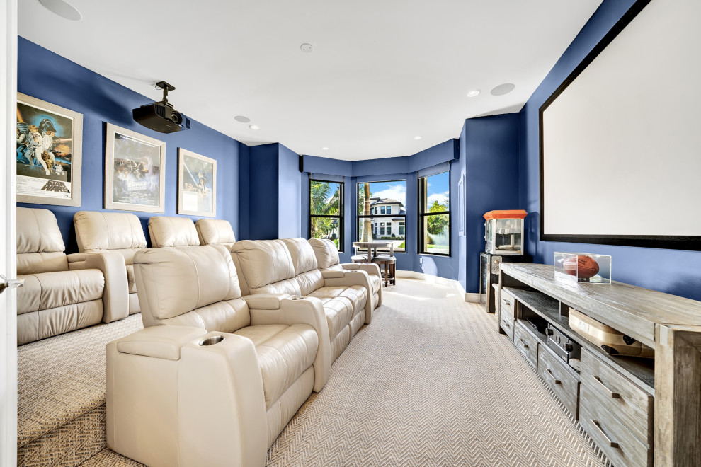 Inspiration for a large beach style enclosed home theatre in Miami with blue walls, carpet, a built-in media wall and beige floor.