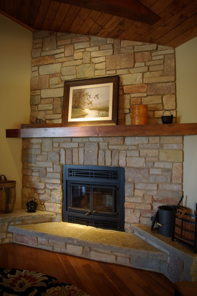 Photo of a mid-sized traditional open concept family room in Milwaukee with yellow walls, medium hardwood floors, a standard fireplace, a stone fireplace surround and a built-in media wall.