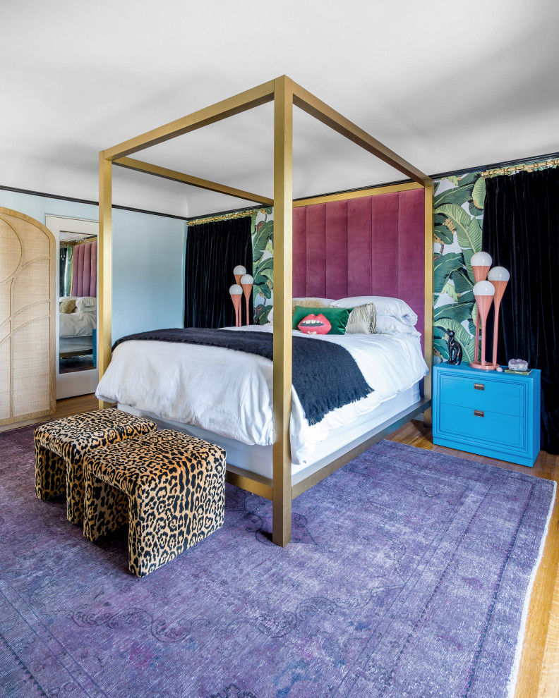 This is an example of a mid-sized eclectic master bedroom in Los Angeles with multi-coloured walls, medium hardwood floors, no fireplace and brown floor.