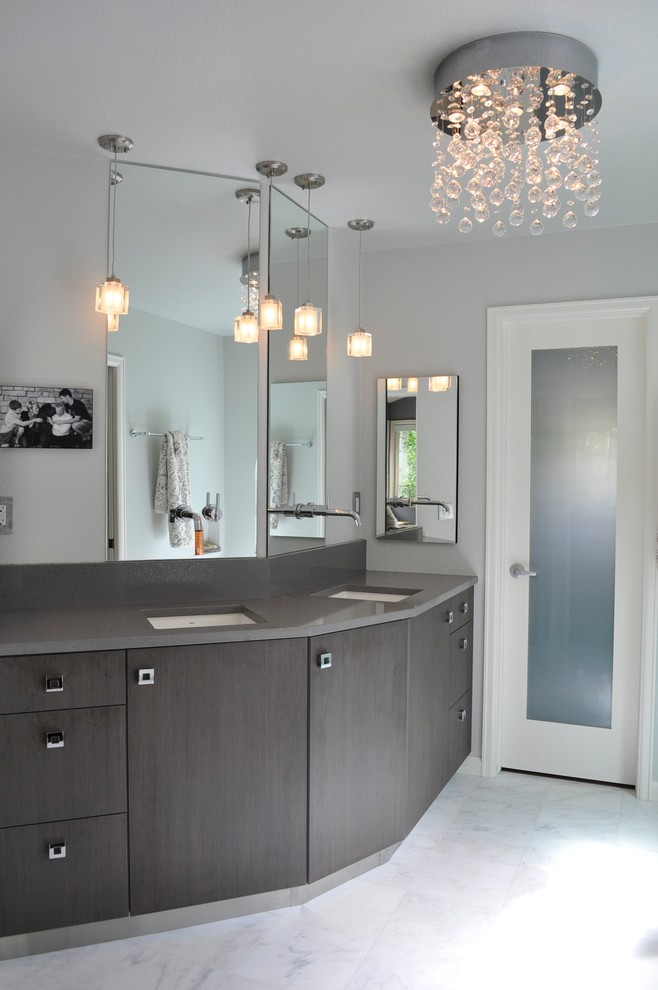 This is an example of a large contemporary master bathroom in Denver with flat-panel cabinets, dark wood cabinets, a freestanding tub, a corner shower, gray tile, white tile, subway tile, grey walls, marble floors, an undermount sink, engineered quartz benchtops and white floor.