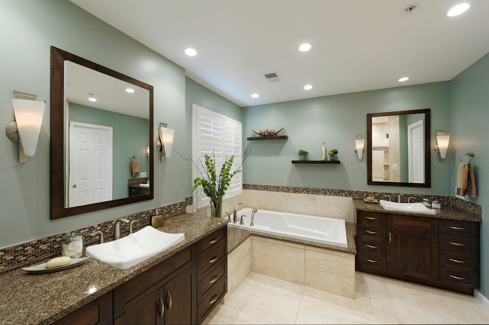 Inspiration for a mid-sized transitional master bathroom in DC Metro with a drop-in sink, shaker cabinets, dark wood cabinets, a corner tub, a corner shower, a one-piece toilet, multi-coloured tile, glass tile, blue walls, porcelain floors and granite benchtops.