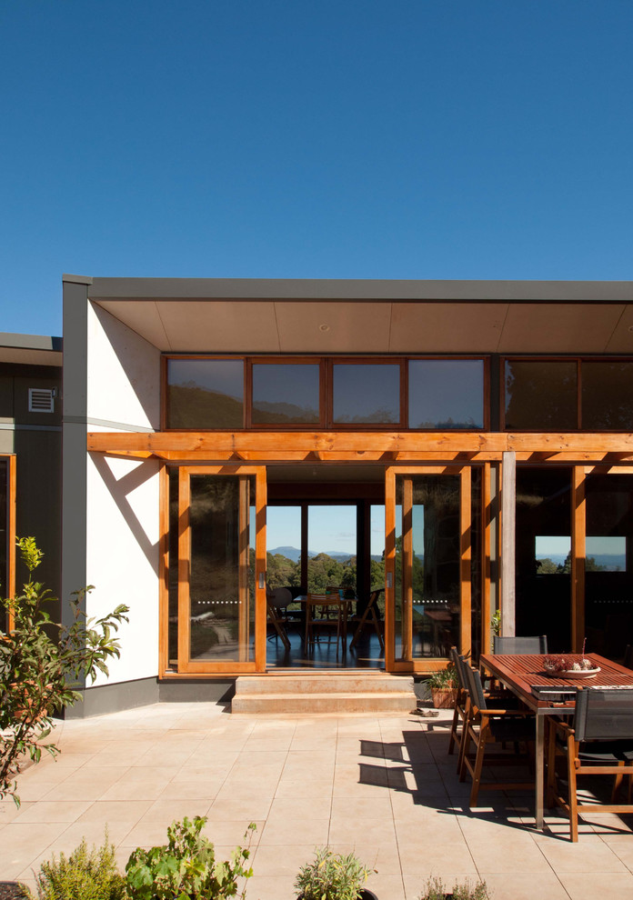 Photo of a large modern courtyard patio in Melbourne with tile and no cover.