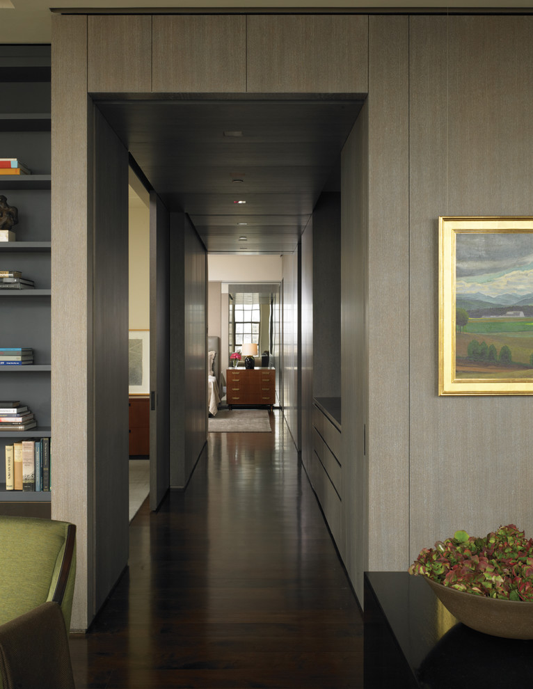 This is an example of a contemporary hallway in New York with grey walls and dark hardwood floors.