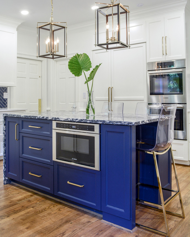 Enclosed kitchen - mid-sized transitional l-shaped medium tone wood floor and brown floor enclosed kitchen idea with an undermount sink, flat-panel cabinets, white cabinets, quartz countertops, blue backsplash, porcelain backsplash, stainless steel appliances, an island and white countertops