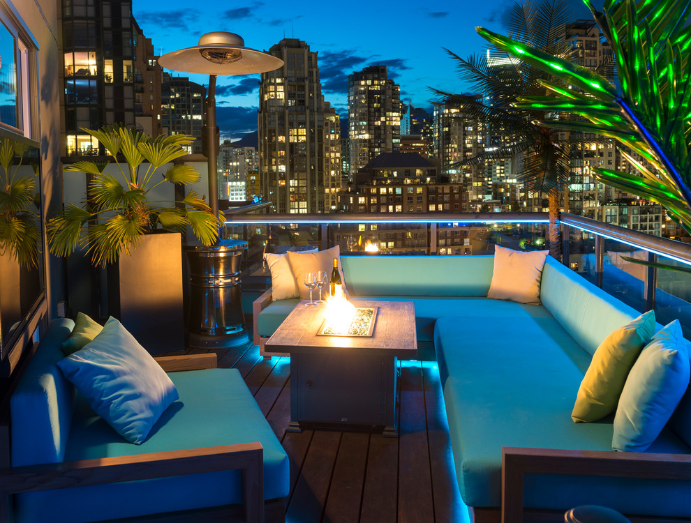 Inspiration for a mid-sized tropical rooftop deck in Vancouver with a fire feature.