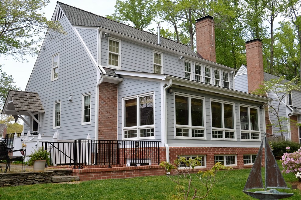 This is an example of a large traditional three-storey exterior in Richmond with mixed siding and a gable roof.