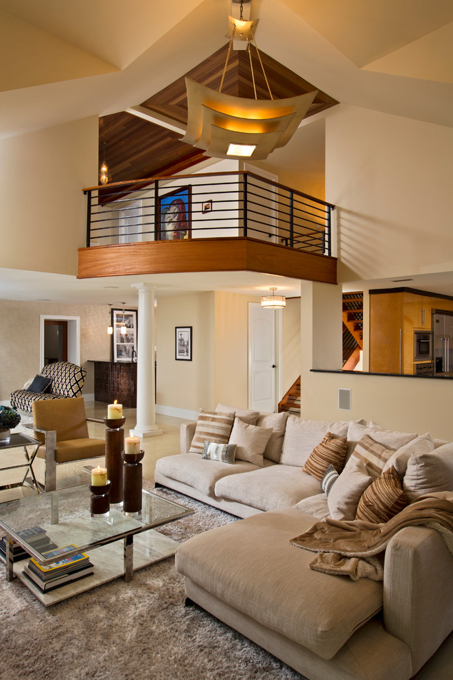 This is an example of a contemporary open concept living room in Boston with beige walls and light hardwood floors.