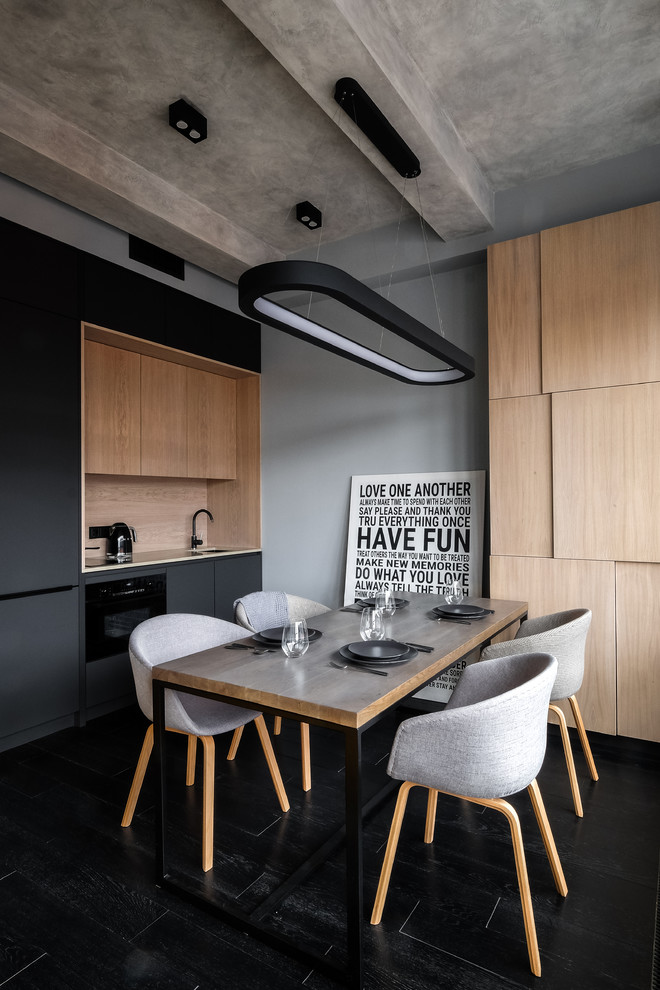 Inspiration for a small contemporary single-wall kitchen in Moscow with an undermount sink, flat-panel cabinets, black cabinets, beige splashback, black appliances and black floor.