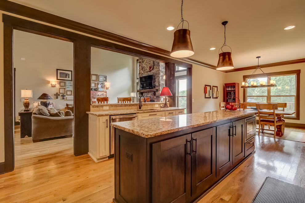 Inspiration for a country galley eat-in kitchen in Nashville with a single-bowl sink, shaker cabinets, white cabinets, granite benchtops, beige splashback, stainless steel appliances and with island.