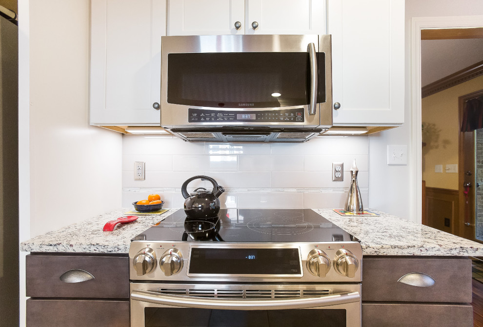 Enclosed kitchen - mid-sized transitional u-shaped porcelain tile enclosed kitchen idea in Birmingham with a double-bowl sink, shaker cabinets, granite countertops, gray backsplash, ceramic backsplash, stainless steel appliances and no island