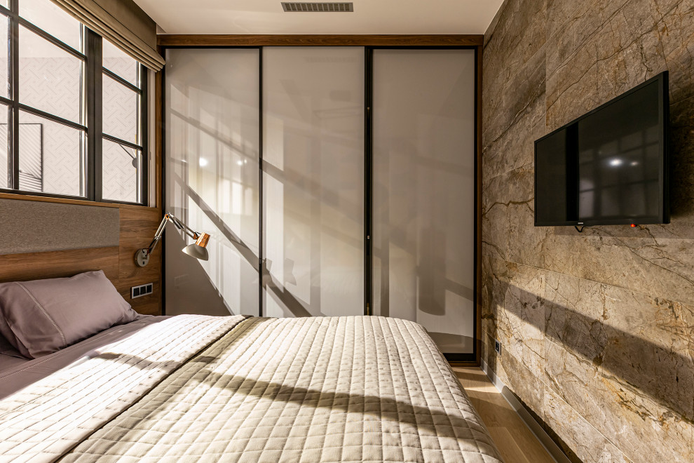 This is an example of a contemporary master bedroom in Saint Petersburg with multi-coloured walls, laminate floors, beige floors and a feature wall.