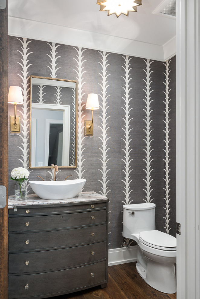 Transitional powder room in Chicago with flat-panel cabinets, grey cabinets, a one-piece toilet, grey walls, dark hardwood floors, a vessel sink, brown floor and white benchtops.
