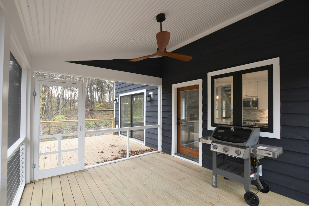 Mid-sized country backyard screened-in verandah in New York with a roof extension.