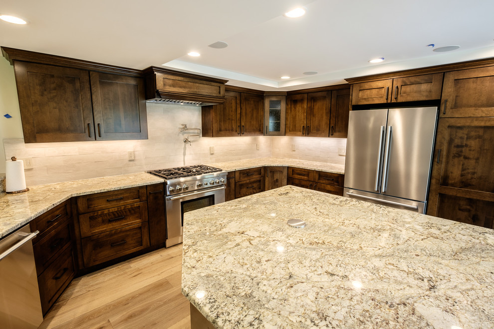 Kitchen - large rustic u-shaped light wood floor and beige floor kitchen idea in Boston with shaker cabinets, dark wood cabinets, granite countertops, beige backsplash, ceramic backsplash, stainless steel appliances, an island and beige countertops