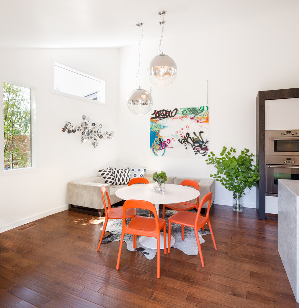 This is an example of a contemporary kitchen/dining combo in Portland with white walls.