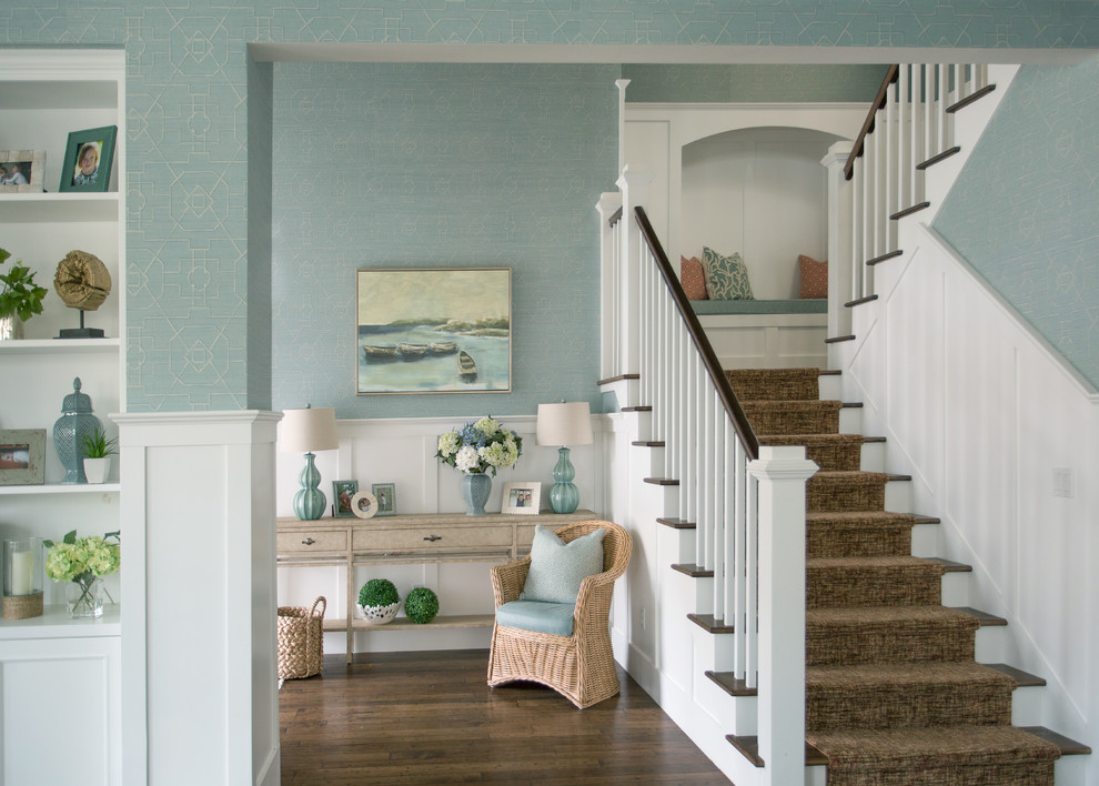 Photo of a large beach style foyer in Los Angeles with blue walls, dark hardwood floors and a single front door.