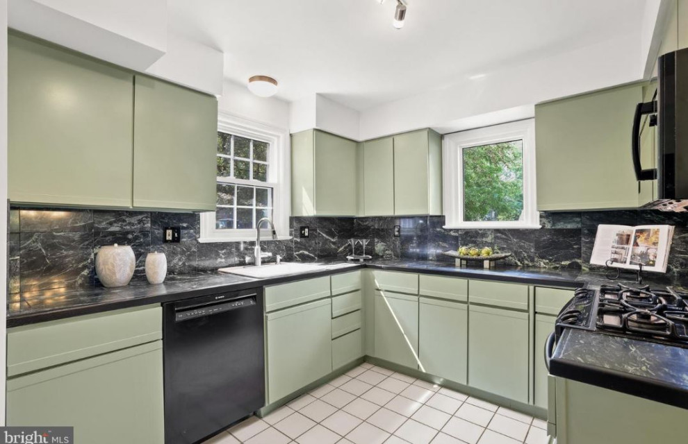 This is an example of a classic kitchen in DC Metro with green cabinets, black splashback, ceramic flooring, white floors and black worktops.