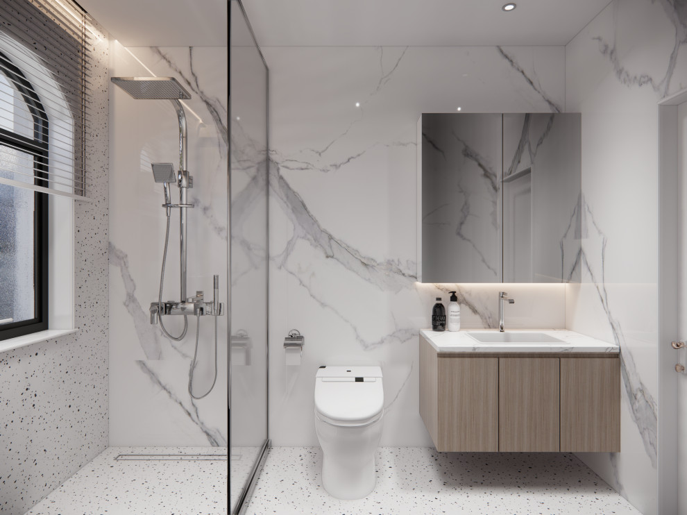 Mid-sized transitional 3/4 white tile and marble tile marble floor, white floor, single-sink and coffered ceiling doorless shower photo with flat-panel cabinets, brown cabinets, a one-piece toilet, white walls, a drop-in sink, marble countertops, white countertops and a freestanding vanity