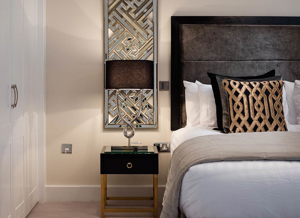 Inspiration for a contemporary master bedroom in Dublin with beige walls and carpet.