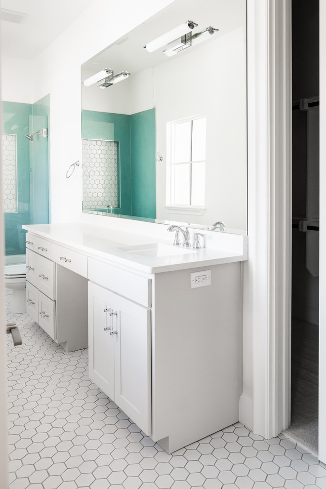 Photo of a mid-sized 3/4 bathroom in Dallas with an alcove tub, a shower/bathtub combo, a two-piece toilet, blue tile, glass tile, white walls, porcelain floors, an undermount sink, engineered quartz benchtops, white floor, a shower curtain and white benchtops.