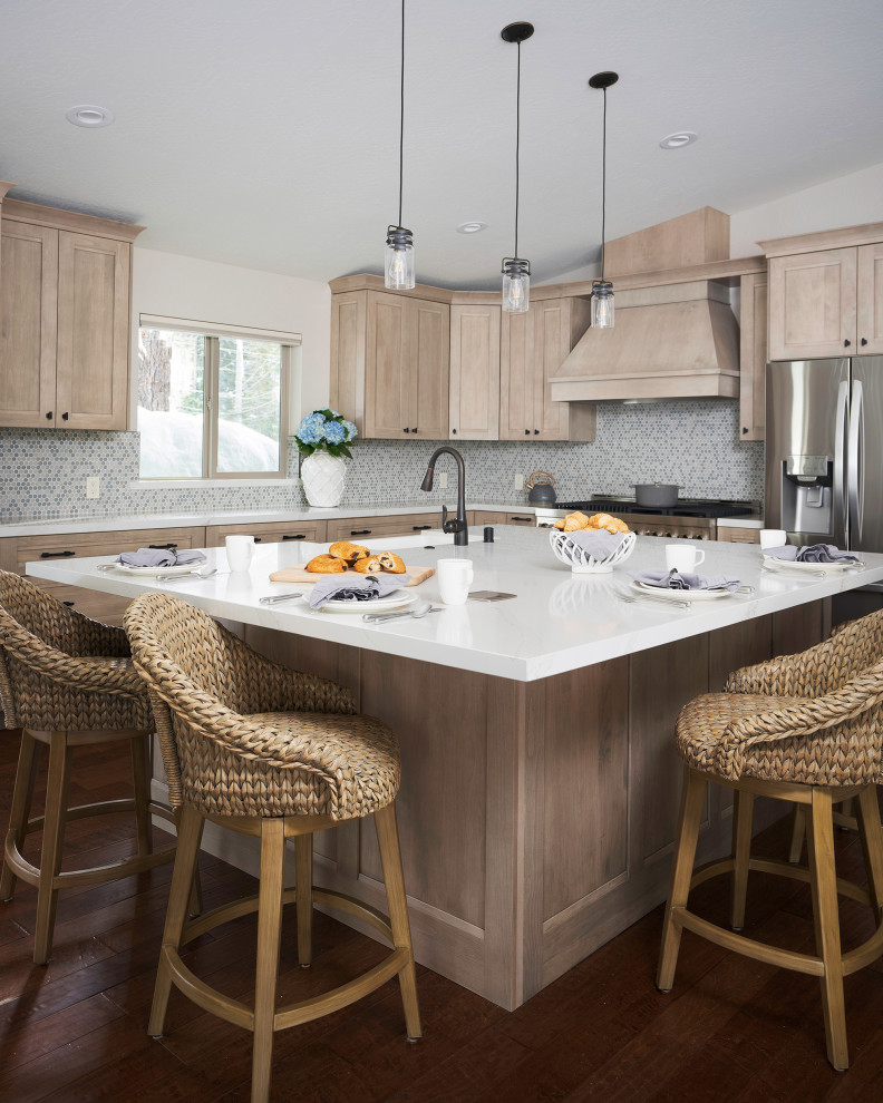 Inspiration for a mid-sized coastal l-shaped medium tone wood floor and brown floor eat-in kitchen remodel in Other with a single-bowl sink, shaker cabinets, light wood cabinets, quartz countertops, blue backsplash, glass sheet backsplash, stainless steel appliances, an island and white countertops
