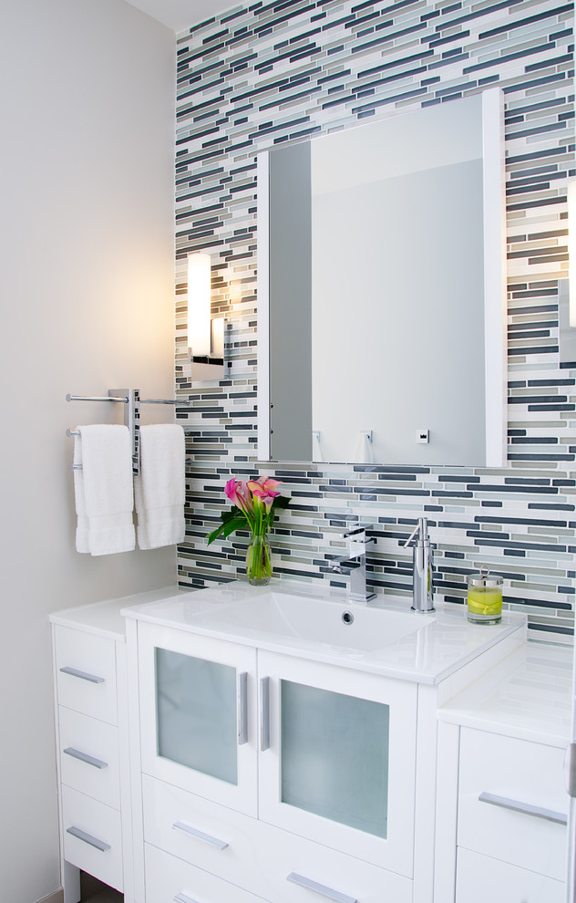 Inspiration for a mid-sized contemporary bathroom in Philadelphia with flat-panel cabinets, white cabinets, multi-coloured tile, matchstick tile, grey walls, a two-piece toilet and an integrated sink.