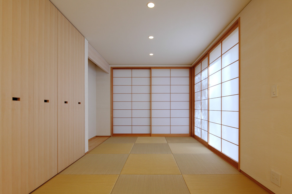 This is an example of an asian home office in Other with white walls, tatami floors and green floor.
