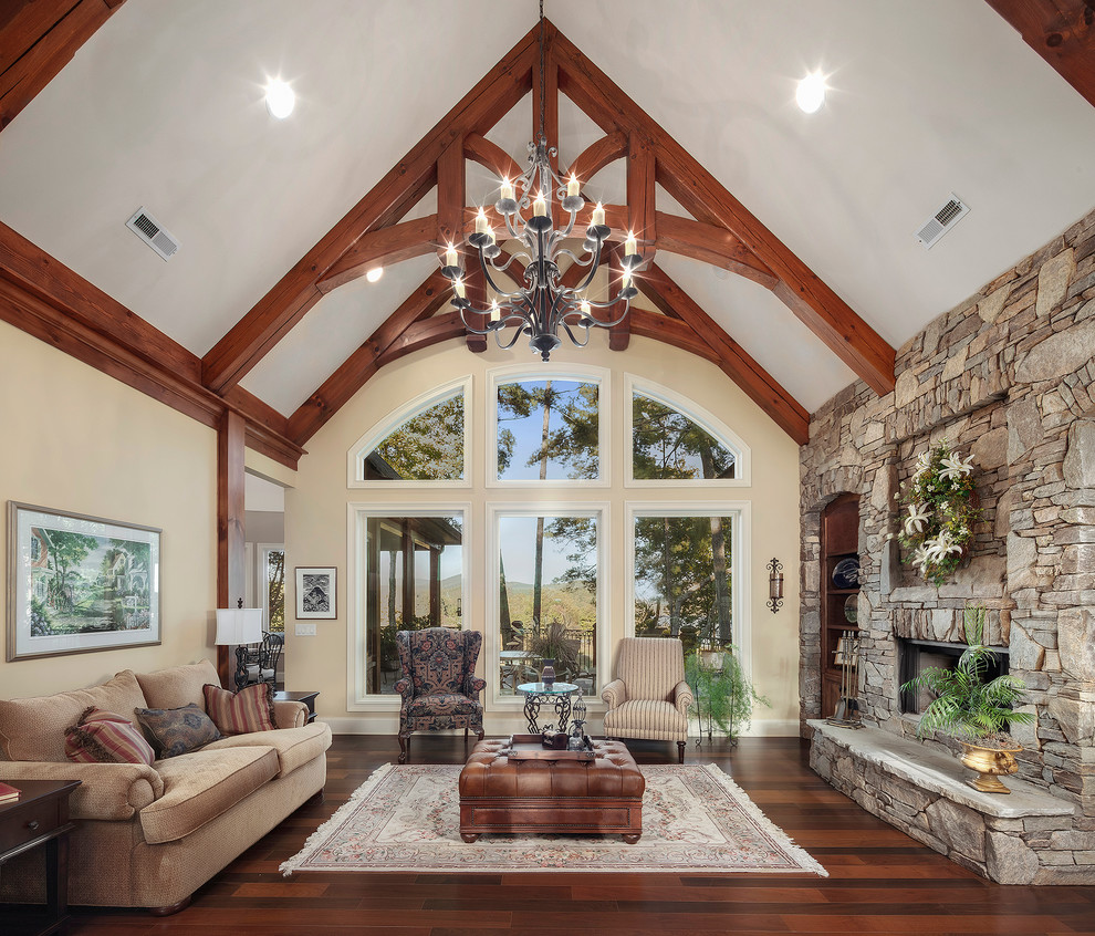 Inspiration for a traditional formal enclosed living room in Other with beige walls, medium hardwood floors, a ribbon fireplace, a stone fireplace surround and no tv.