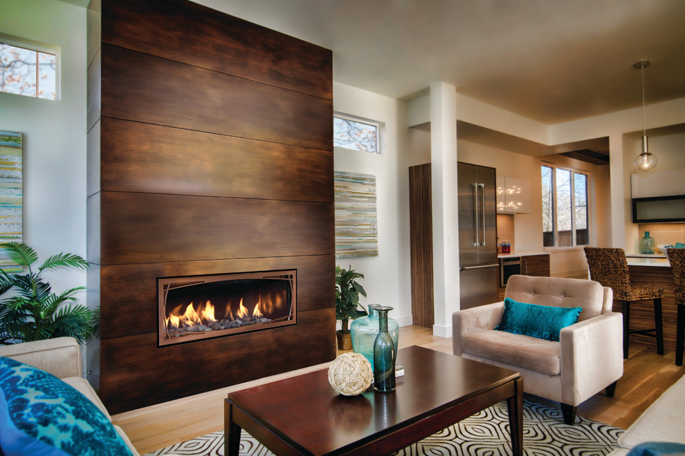 Inspiration for a mid-sized contemporary formal open concept living room in Cedar Rapids with beige walls, light hardwood floors, a ribbon fireplace, a wood fireplace surround, no tv and brown floor.