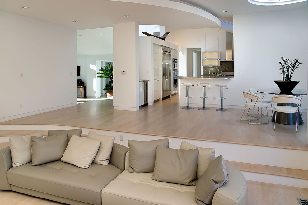 This is an example of a modern open concept living room in San Francisco with white walls.