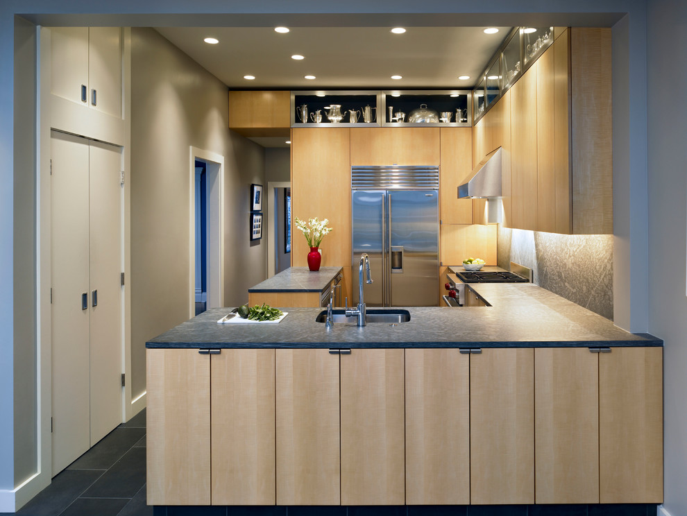 This is an example of a contemporary kitchen in San Francisco with flat-panel cabinets, light wood cabinets and a peninsula.