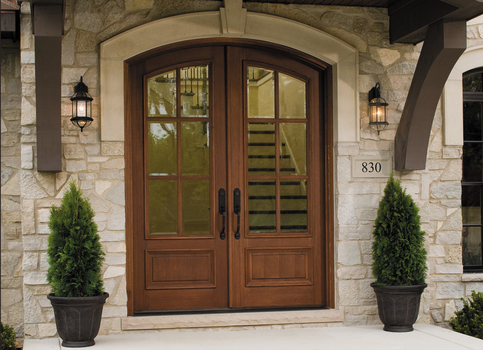 This is an example of a large arts and crafts front door in Austin with a double front door and a dark wood front door.