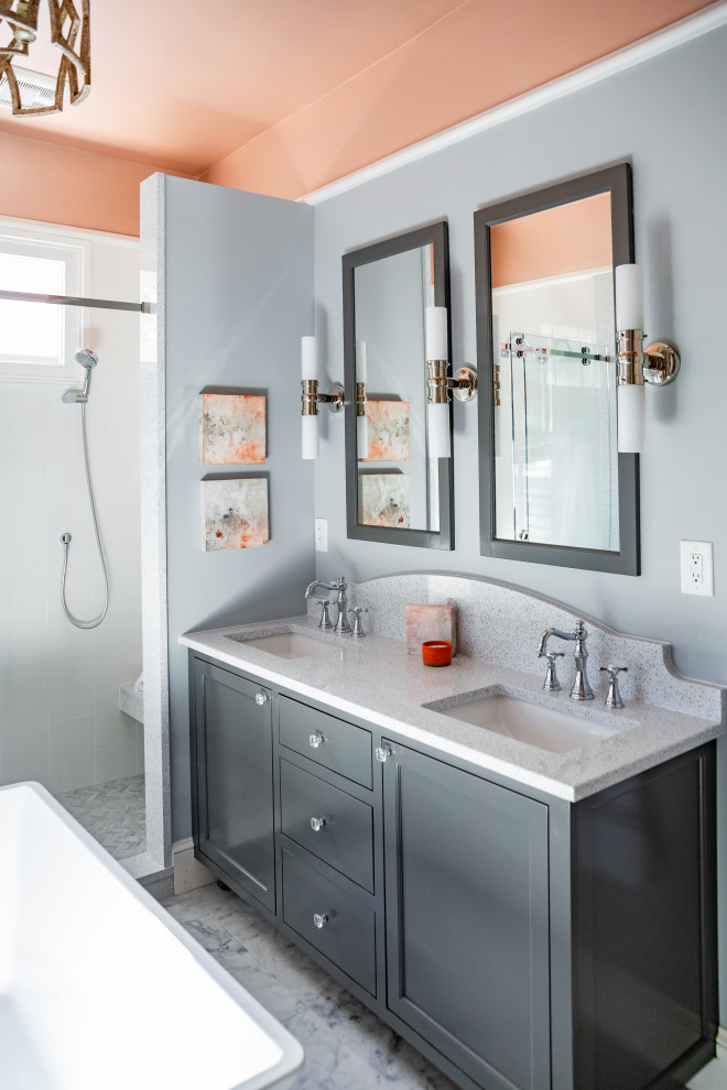 Inspiration for a mid-sized transitional master bathroom in Charleston with shaker cabinets, grey cabinets, a freestanding tub, an alcove shower, a two-piece toilet, white tile, porcelain tile, an undermount sink, grey floor, white benchtops, a shower seat, a double vanity, a built-in vanity, grey walls, marble floors, engineered quartz benchtops and a sliding shower screen.