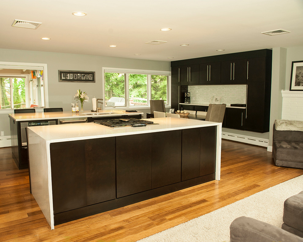 Kitchen photo in Chicago with flat-panel cabinets, dark wood cabinets and two islands