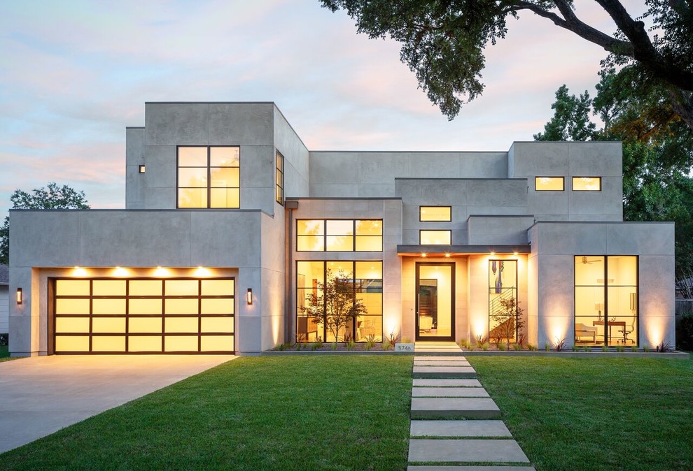 This is an example of a large contemporary two-storey stucco grey house exterior in Dallas with a flat roof.