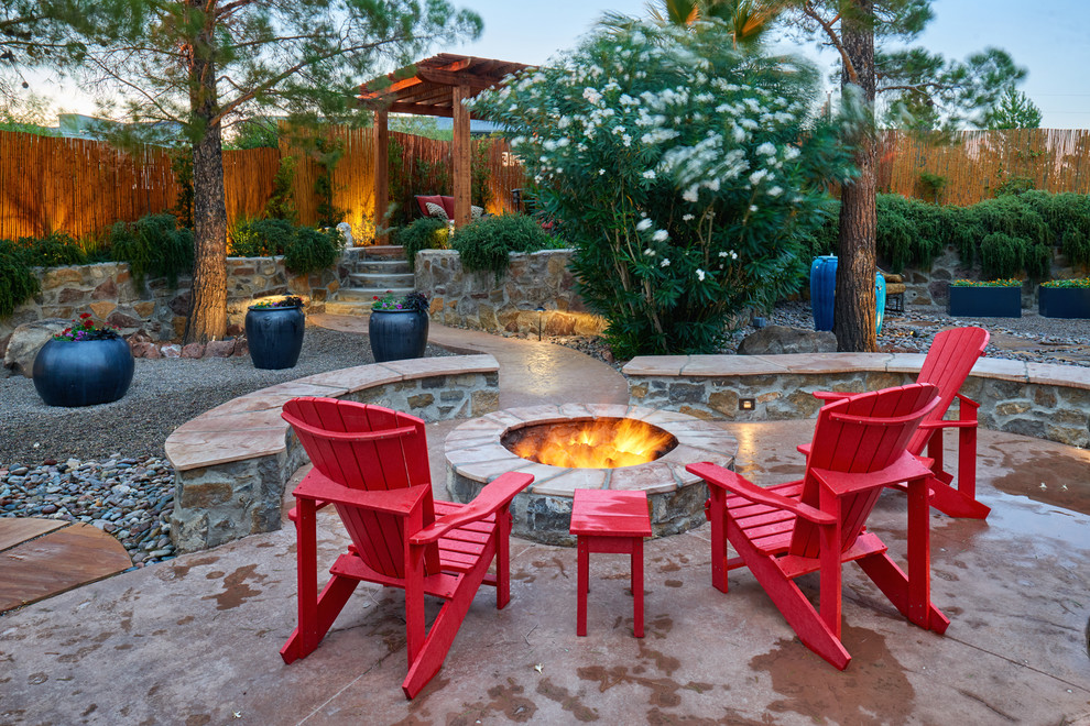 Inspiration for a backyard patio in Other with a fire feature, concrete slab and a pergola.
