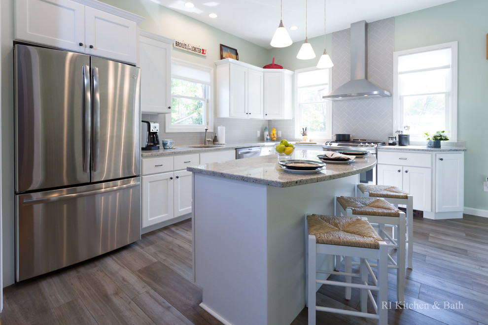 Example of a large transitional l-shaped porcelain tile eat-in kitchen design in Providence with an undermount sink, recessed-panel cabinets, white cabinets, granite countertops, gray backsplash, ceramic backsplash, stainless steel appliances, green walls and an island