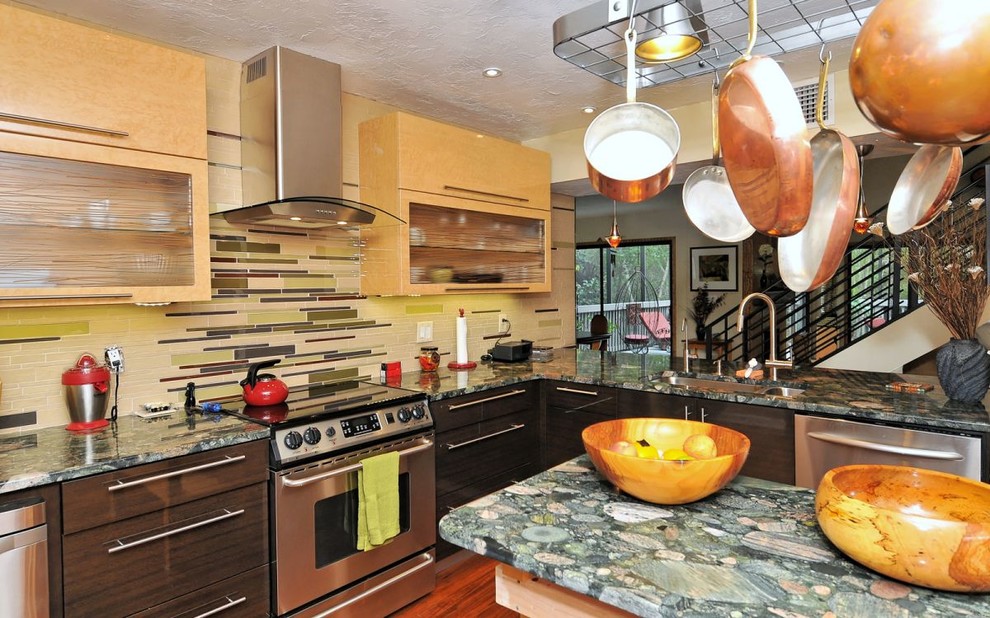 Photo of a small eclectic u-shaped eat-in kitchen in Tampa with an undermount sink, flat-panel cabinets, light wood cabinets, granite benchtops, multi-coloured splashback, glass tile splashback, stainless steel appliances, bamboo floors, with island and brown floor.