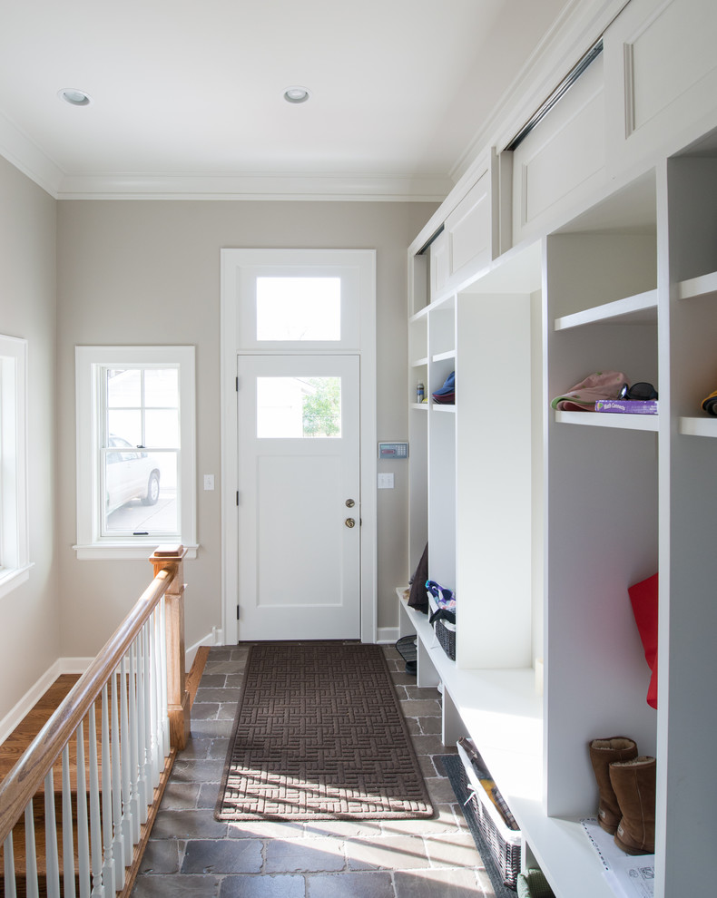 Design ideas for a transitional mudroom in Chicago with grey walls and a single front door.