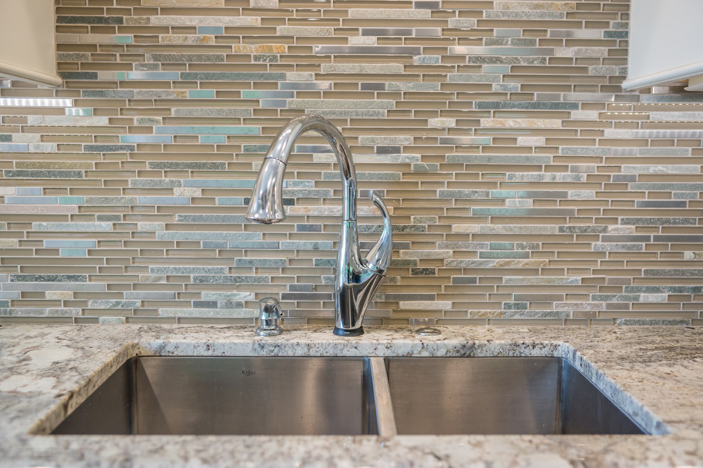 Huge transitional l-shaped medium tone wood floor eat-in kitchen photo in Birmingham with an undermount sink, white cabinets, granite countertops, multicolored backsplash, glass tile backsplash, stainless steel appliances, an island and recessed-panel cabinets