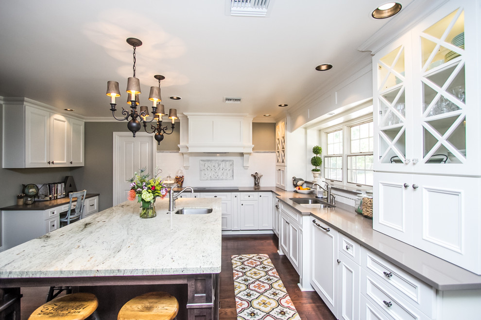 Large transitional u-shaped dark wood floor and brown floor eat-in kitchen photo in Phoenix with a double-bowl sink, recessed-panel cabinets, white cabinets, quartzite countertops, white backsplash, ceramic backsplash, paneled appliances and an island