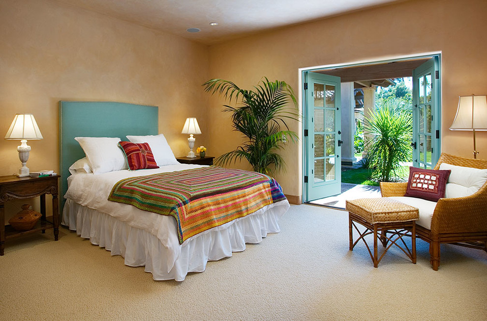 Photo of an eclectic bedroom in Santa Barbara with beige walls and carpet.