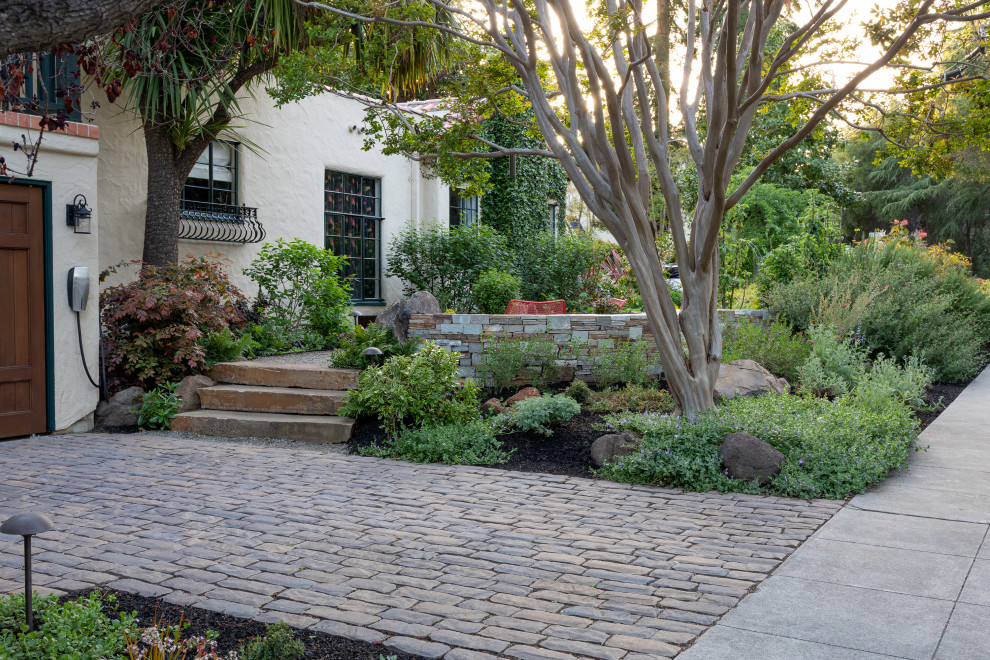 Inspiration for a mid-sized mediterranean front yard full sun driveway in San Francisco with a retaining wall and concrete pavers.