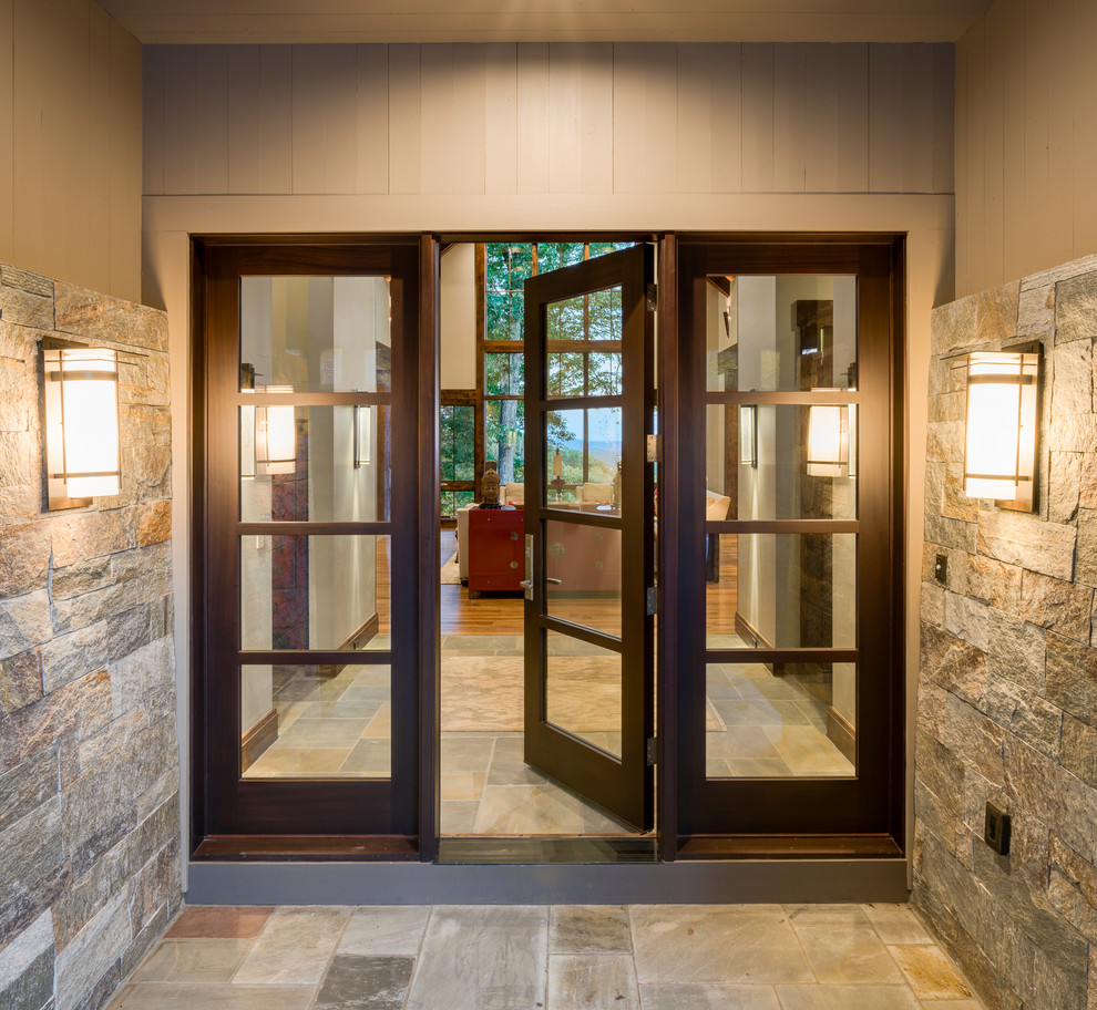 Front door - large transitional slate floor front door idea with beige walls and a dark wood front door